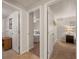 Hallway leading to bedrooms with neutral walls and tile and carpet flooring throughout at 18417 Ohara Dr, Port Charlotte, FL 33948