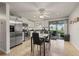 Eat-in kitchen with stainless steel appliances, white cabinetry, tile flooring, and a sliding glass door leading to the lanai at 18417 Ohara Dr, Port Charlotte, FL 33948