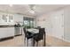Bright eat-in kitchen featuring stainless steel appliances, white cabinets, tiled floor, and views of the screened-in lanai at 18417 Ohara Dr, Port Charlotte, FL 33948