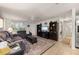 Comfortable living room featuring neutral walls, tile flooring, large windows with shutters, a ceiling fan, and elegant furnishings at 18417 Ohara Dr, Port Charlotte, FL 33948