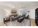 Comfortable living room featuring neutral walls, tile flooring, large windows with shutters, a ceiling fan, and elegant furnishings at 18417 Ohara Dr, Port Charlotte, FL 33948
