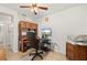 Bright office with a built-in desk and shelves, and a large office chair and computer at 18417 Ohara Dr, Port Charlotte, FL 33948