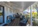 Relaxing screened patio with comfortable seating and ceiling fans, perfect for enjoying the outdoors at 18417 Ohara Dr, Port Charlotte, FL 33948