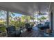 Inviting screened patio featuring comfortable lounge chairs and serene views of the lush greenery and canal at 18417 Ohara Dr, Port Charlotte, FL 33948