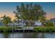 Picturesque waterfront home featuring a private boat dock and lush green lawn at 18417 Ohara Dr, Port Charlotte, FL 33948