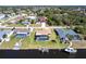 Aerial view showcasing a home with a pool, a dock, and waterfront access at 18462 Alphonse Cir, Port Charlotte, FL 33948