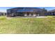 Expansive backyard featuring a screened-in pool and ample green space at 18462 Alphonse Cir, Port Charlotte, FL 33948
