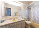 Bathroom featuring a sink, vanity with storage, a large mirror and a shower at 18462 Alphonse Cir, Port Charlotte, FL 33948