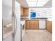 Bright and airy kitchen with white refrigerator, light cabinets and open layout, perfect for entertaining at 18462 Alphonse Cir, Port Charlotte, FL 33948
