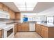 Well-lit kitchen with ample counter space, light wood cabinets, and an open layout with a view to the living area at 18462 Alphonse Cir, Port Charlotte, FL 33948
