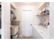 Bright laundry room featuring a utility sink, shelving, and a washer and dryer at 18462 Alphonse Cir, Port Charlotte, FL 33948