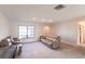 Spacious living room featuring tile flooring, neutral paint, large window, and comfortable seating at 18462 Alphonse Cir, Port Charlotte, FL 33948