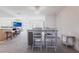 Open living area with tile flooring, a kitchen bar, and a dining area with seating for four at 18462 Alphonse Cir, Port Charlotte, FL 33948