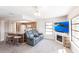 Inviting living room featuring a cozy fireplace, television, and open access to the kitchen at 18462 Alphonse Cir, Port Charlotte, FL 33948