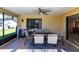 Relaxing screened patio with ceiling fan and outdoor dining set, perfect for entertaining at 18462 Alphonse Cir, Port Charlotte, FL 33948