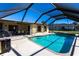 Beautiful screened-in pool with clear blue water, surrounded by a spacious patio area at 18462 Alphonse Cir, Port Charlotte, FL 33948