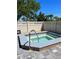 Private hot tub with tiled trim and a metal grab bar, perfect for relaxation at 21405 Olean Blvd # 308, Port Charlotte, FL 33952