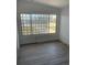 Bright living room features decorative windows and sleek gray laminate flooring at 22262 Midway Blvd, Port Charlotte, FL 33952