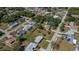 Aerial view of single-Gathering home surrounded by tree-lined streets and lawns with mature trees at 23051 Elmira Blvd, Punta Gorda, FL 33980