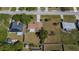 Aerial view of single-Gathering home surrounded by tree-lined streets and lawns with mature trees at 23051 Elmira Blvd, Punta Gorda, FL 33980
