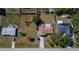 Aerial view of single-Gathering home featuring a lawn with mature trees and a private backyard at 23051 Elmira Blvd, Punta Gorda, FL 33980