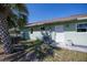 A rear view of the property, showing backyard, siding, door, and HVAC at 23051 Elmira Blvd, Punta Gorda, FL 33980