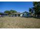 Spacious backyard featuring lush green lawn, and an outdoor patio perfect for entertaining at 23051 Elmira Blvd, Punta Gorda, FL 33980