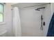 Modern bathroom featuring a subway tile shower with black fixtures and black and white tile floor at 23051 Elmira Blvd, Punta Gorda, FL 33980