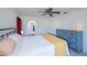 Bedroom features ceiling fan, tile flooring, and view into attached bathroom at 23051 Elmira Blvd, Punta Gorda, FL 33980