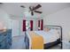 Bedroom featuring ceiling fan, tile flooring, and large dresser at 23051 Elmira Blvd, Punta Gorda, FL 33980