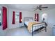 Bright bedroom with ceiling fan, tile flooring, and view into attached bathroom at 23051 Elmira Blvd, Punta Gorda, FL 33980