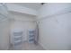 Walk-in closet with shelving, plastic storage bins, and ironing board at 23051 Elmira Blvd, Punta Gorda, FL 33980