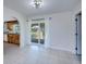 Bright dining area with neutral tile, view of the backyard, and archway to the kitchen at 23051 Elmira Blvd, Punta Gorda, FL 33980