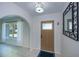 Inviting entryway featuring an arched doorway, tile floors, and a decorative mirror at 23051 Elmira Blvd, Punta Gorda, FL 33980