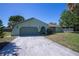 Charming single-story home featuring a long driveway, two-car garage, and mature landscaping at 23051 Elmira Blvd, Punta Gorda, FL 33980
