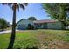 Charming single-story home featuring a two-car garage, arched entry and mature landscaping at 23051 Elmira Blvd, Punta Gorda, FL 33980