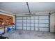Garage with utility bench, tools, and storage; closed garage door at 23051 Elmira Blvd, Punta Gorda, FL 33980