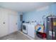 Laundry room with washer, dryer, water heater, and concrete floors at 23051 Elmira Blvd, Punta Gorda, FL 33980