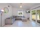 Living room with a large grey sectional couch and access to the backyard at 23051 Elmira Blvd, Punta Gorda, FL 33980