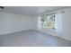 Bright living room with neutral tile and large window providing plenty of natural light with a view of the neighborhood at 23051 Elmira Blvd, Punta Gorda, FL 33980