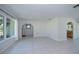 Bright living room with neutral tile, and archways to other rooms providing great flow and natural light at 23051 Elmira Blvd, Punta Gorda, FL 33980