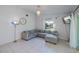 Bright living room features tile floors, neutral paint, and comfortable sectional sofa at 23051 Elmira Blvd, Punta Gorda, FL 33980