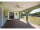 An arched, covered patio with ceiling fan and slider access to the home's interior at 23051 Elmira Blvd, Punta Gorda, FL 33980