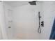 Updated walk-in shower features white subway tile and black shower head at 23051 Elmira Blvd, Punta Gorda, FL 33980