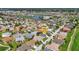 Aerial view of the property showcasing location amongst similar homes, lush landscaping, and nearby community amenities at 24055 Buckingham Way, Punta Gorda, FL 33980