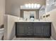 Bathroom showcasing double sink vanity with marble countertop and tiled walk-in shower at 24055 Buckingham Way, Punta Gorda, FL 33980