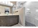 Bathroom featuring a dual sink vanity with a sleek tiled shower and modern finishes at 24055 Buckingham Way, Punta Gorda, FL 33980