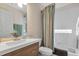 Bathroom featuring a modern vanity and shower-tub combination with a stylish shower curtain at 24055 Buckingham Way, Punta Gorda, FL 33980