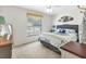 Cozy bedroom with a comfortable bed, a large window, and tasteful decor at 24055 Buckingham Way, Punta Gorda, FL 33980