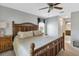 Bedroom featuring a large decorative headboard bed, ceiling fan, and en suite bath at 24055 Buckingham Way, Punta Gorda, FL 33980